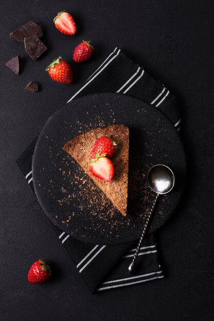 Top view tasty cake with strawberry on a plate