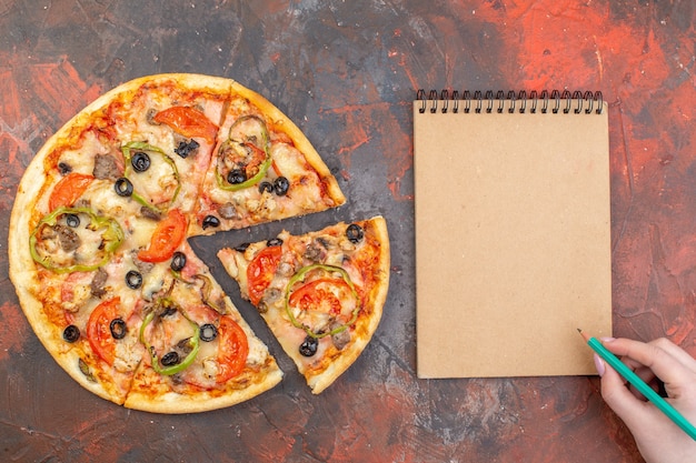 Free Photo top view tasty cheese pizza sliced and served on a dark brown surface