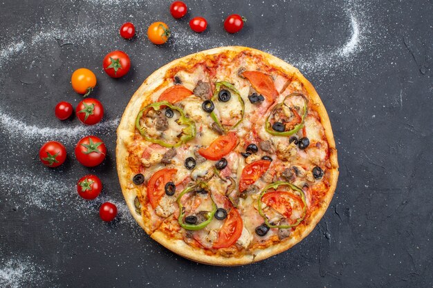 Top view tasty cheese pizza with red tomatoes on dark surface