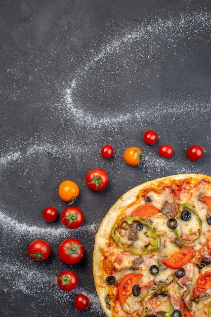 Free Photo top view tasty cheese pizza with red tomatoes on dark surface