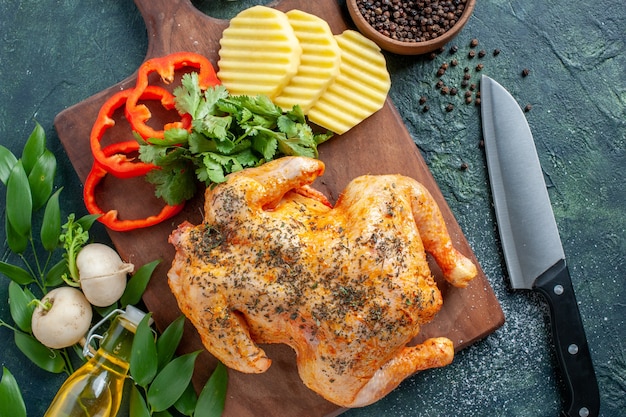 Free Photo top view tasty cooked chicken spiced up with potatoes on dark background meat color dish restaurant food dinner meal