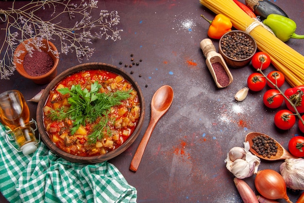 Free photo top view tasty cooked vegetables sauce meal with different seasonings and tomatoes on dark background sauce meal dish food