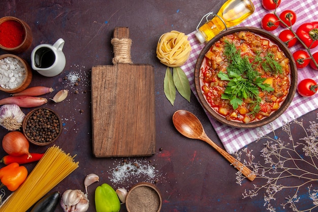 Top view tasty cooked vegetables sauce meal with tomatoes and seasonings on dark background meal sauce dish food