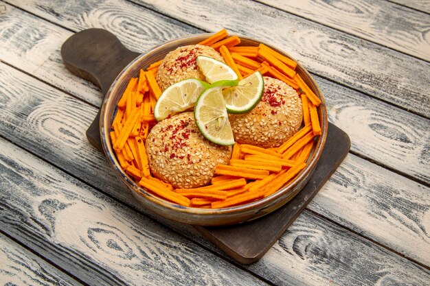 Top view tasty cookies with lemon slices and rusks on the rustic grey desk snack biscuit sugar sweet cake cookie