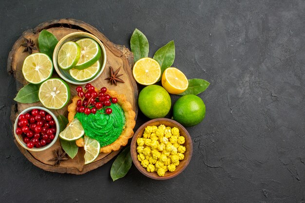 Top view tasty creamy cake with fruits on dark background cookie biscuit sweet