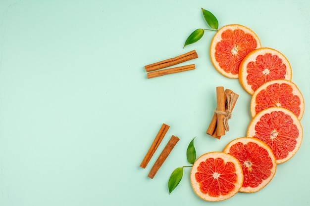 Free Photo top view of tasty fresh grapefruits juicy fruit slices on the light-blue surface