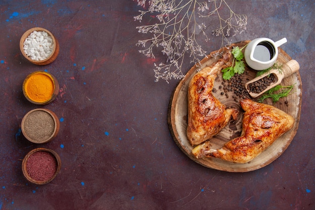 Top view tasty fried chicken with seasonings on dark background food chicken meal vegetable meat