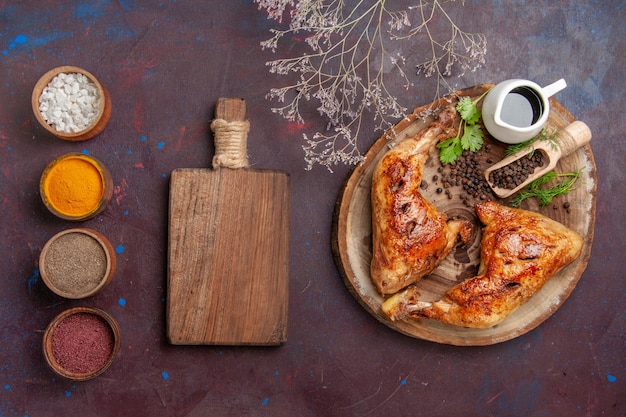 Top view tasty fried chicken with seasonings on dark desk food chicken vegetable meat meal