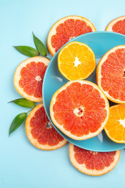 Free Photo top view of tasty grapefruits fruit slices on a blue surface