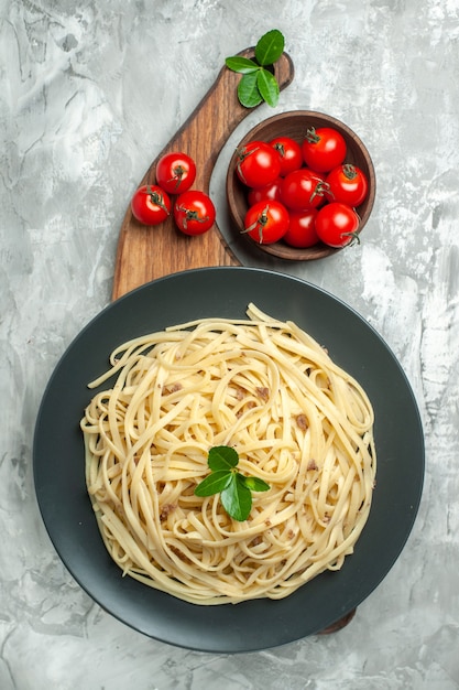 Top view tasty italian pasta with cherry tomatoes on light background