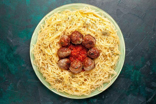 Free Photo top view tasty italian pasta with meatballs on dark-blue background