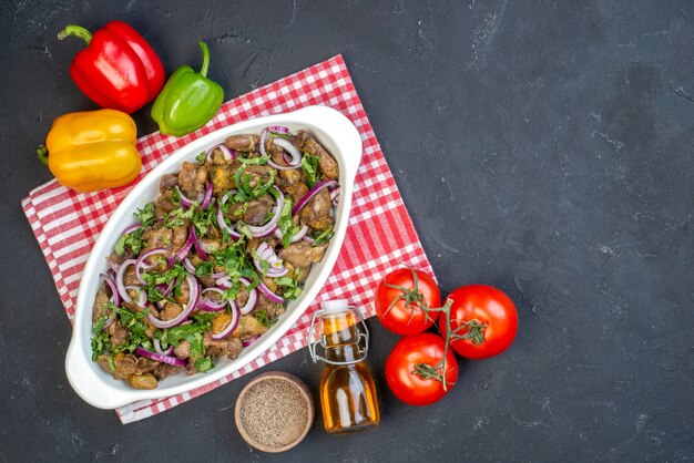 Top view tasty kebab bowl colored bell peppers tomatoes oil bottle on table with free space