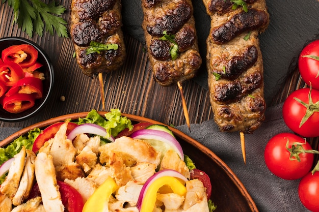 Top view of tasty kebab with tomatoes and other dish