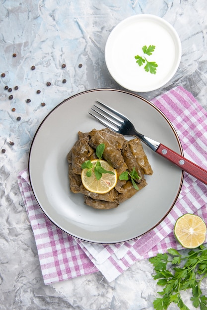 Free Photo top view tasty leaf dolma with yogurt on white background