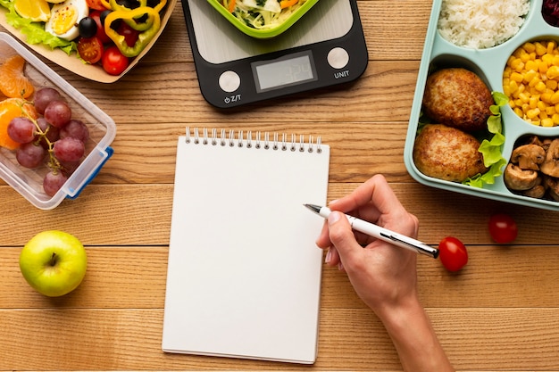 Free photo top view tasty meal arrangement with empty notebook