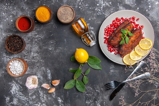 Free Photo top view tasty meat cutlets with seasonings on the grey background dish photo food