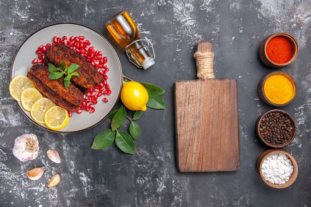 Top view tasty meat cutlets with seasonings on grey background meal food dish