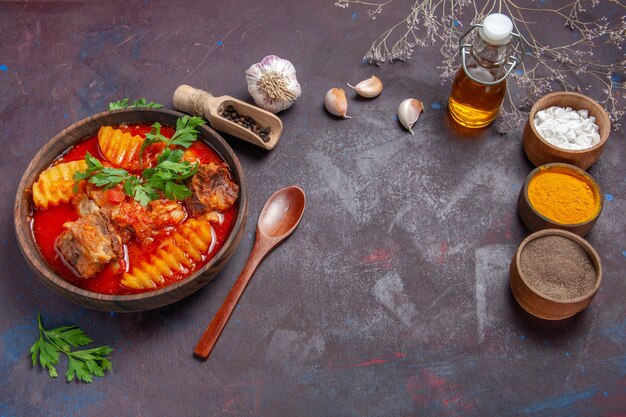 Top view tasty meat sauce with different seasonings on black