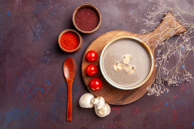 Top view tasty mushroom soup with different seasonings on dark background soup meal mushroom seasonings food