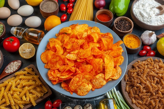 Free photo top view tasty pepper cips with different seasonings and ingredients on a dark background color food meal photo pasta