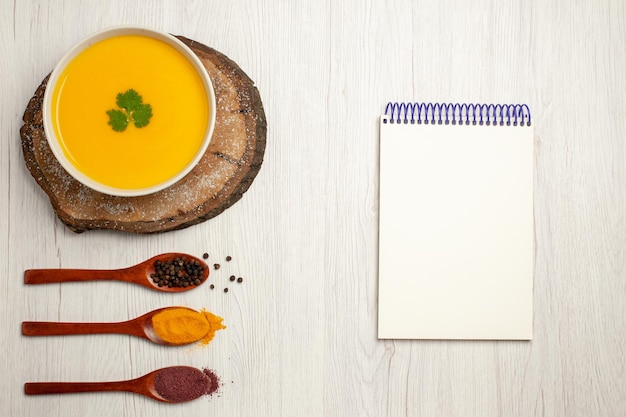 Free Photo top view of tasty pumpkin soup with pepper on white