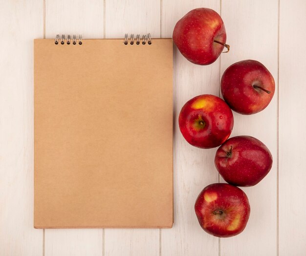 Top view of tasty red apples isolated on a white wooden surface with copy space