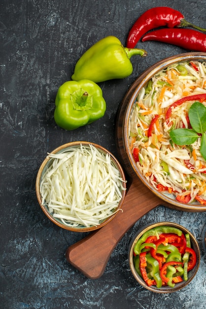 Free photo top view of tasty salad with fresh vegetables on dark surface