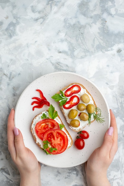 Top view tasty sandwiches with tomatoes and olives on white background food health meal bread lunch horizontal toast burgers