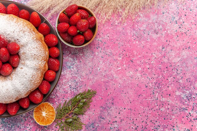 Top view tasty strawberry pie with sugar powder on light-pink