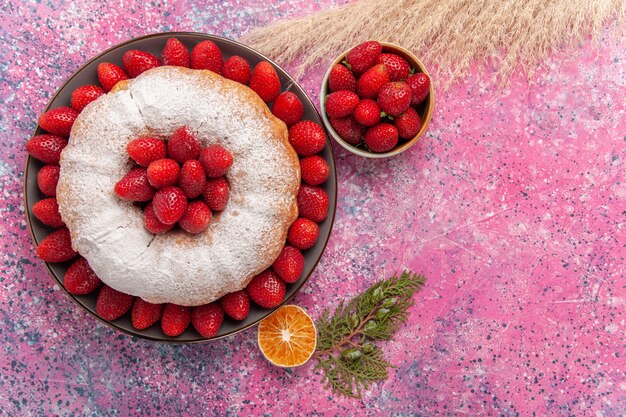 Top view tasty strawberry pie with sugar powder on the pink