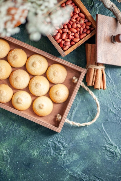 Free Photo top view tasty sweet biscuits with peanuts on dark background color nut cookie sweet cake pie sugar