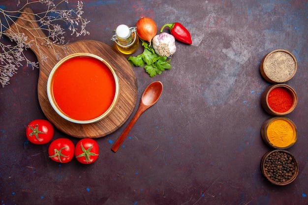 Free Photo top view of tasty tomato soup with seasonings and fresh tomatoes on dark