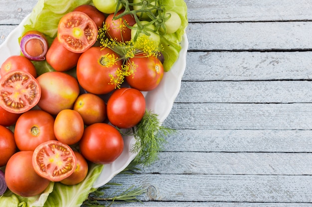 Top view tasty tomatoes plate with copy space