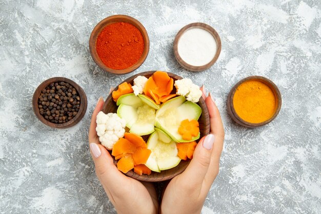 Top view tasty useful salad with seasonings on white background salad vegetables meal food health