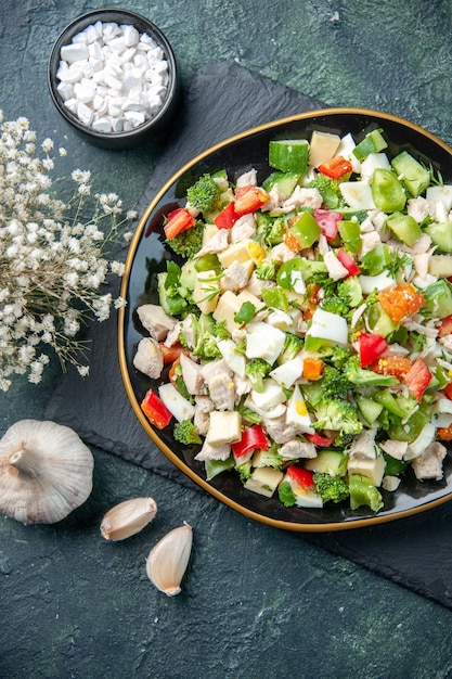 top view tasty vegetable salad inside plate with fork on dark background restaurant meal color health diet fresh cuisine food