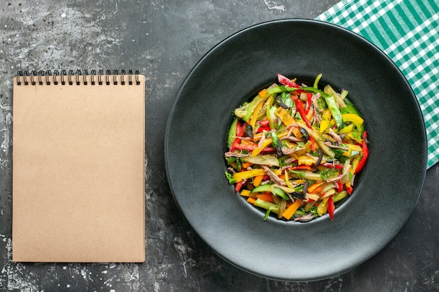 Top view of tasty vegetables on dark surface