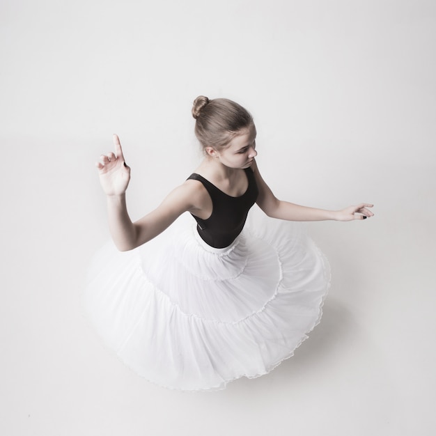 The top view of the teen ballerina on white