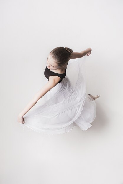 The top view of the teen ballerina on white