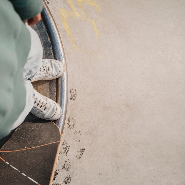 Free photo top view of teenager with skateboard and copy space