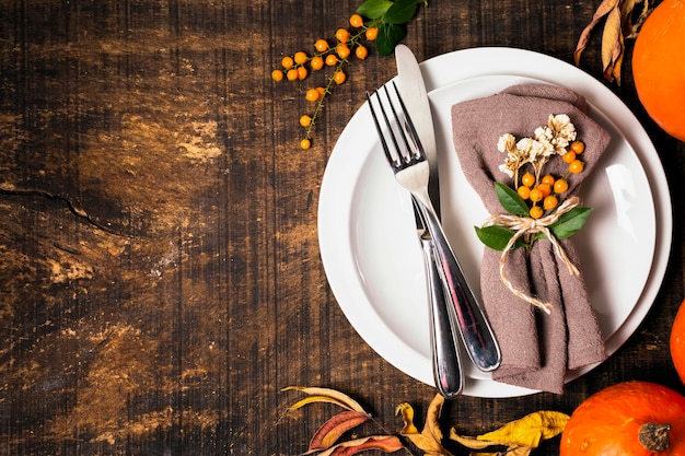 Top view of thanksgiving dinner table arrangement with cutlery and copy space