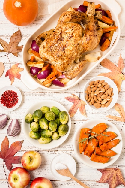 Top view of thanksgiving table with roasted chicken and other dishes