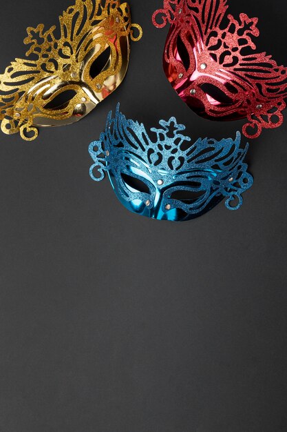 Top view of three masks for carnival with copy space