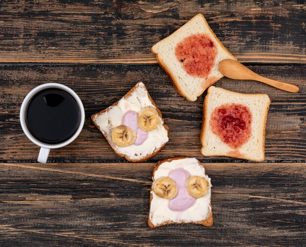 Top view of toasts with coffee dark wooden surface horizontal