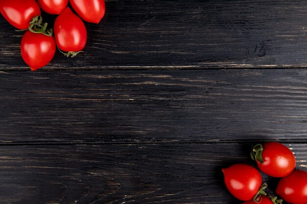 Top view of tomatoes on left and right sides and wood with copy space