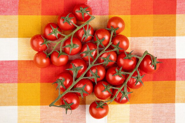 Top view of tomatoes on plaid cloth surface