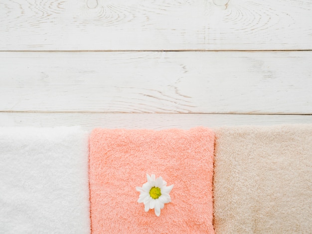 Top view towels on wooden background with copy space