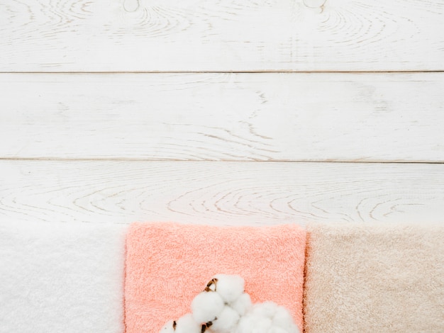 Free Photo top view towels on wooden background with copy space