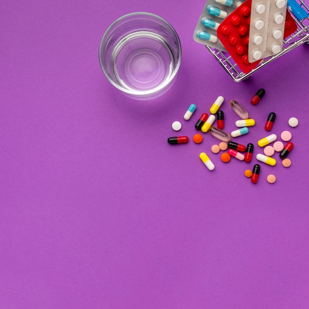 Free photo top view toy cart with clock and pills beside