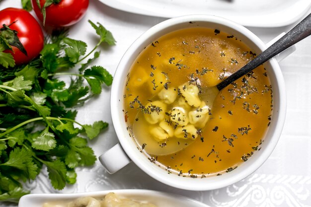 Free Photo top view a traditional azerbaijani dish dushbara with parsley and tomatoes