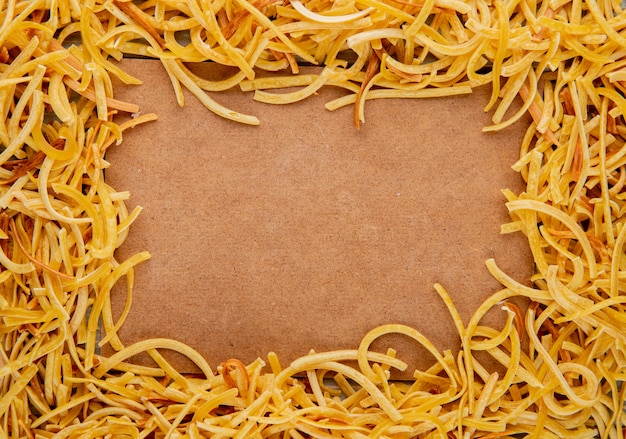 Top view of traditional homemade italian raw pasta with copy space on carton background